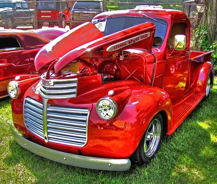Old red truck parked in lot