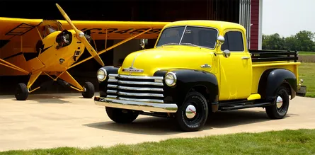 Two yellow trucks, one on left, one on right