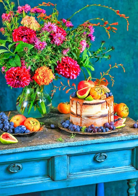 Cake with fruit, blue table, flowers