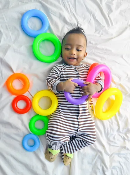 Baby with toys around