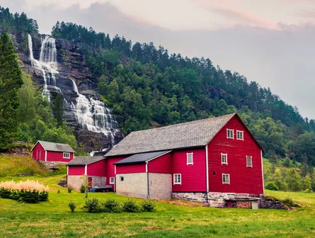 Farmhouse waterfall green trees sky mountain pasture landscape