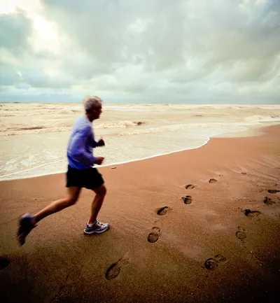 Old man running on beach
