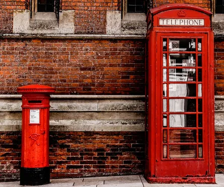 Red brick wall phone booth red london telephone box