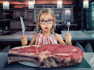 Girl holding knife with meat