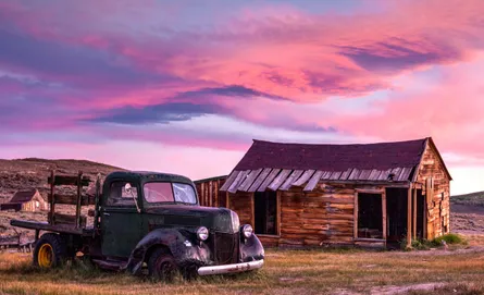 Old truck in front of barn
