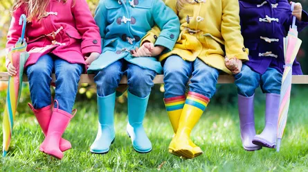 Kids wearing boots and raincoats