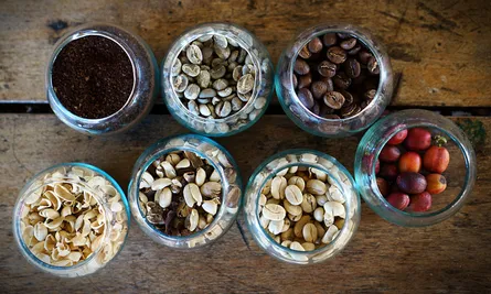 Six jars of nuts and seeds on table