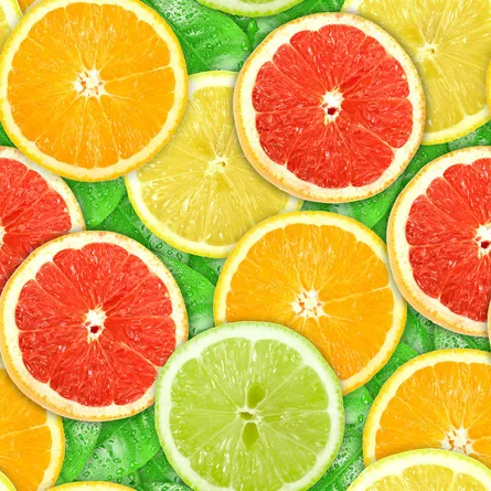Sliced colorful oranges with slices of lime next to them