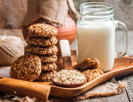 A jar of milk, cookies and oat meal