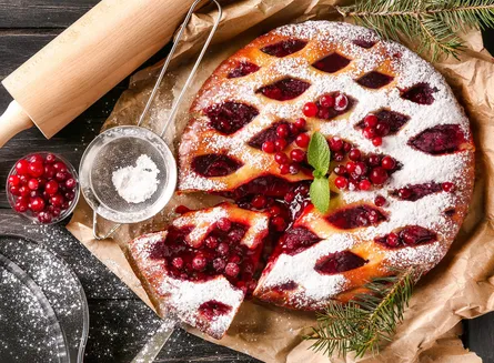 Delicious dessert, red berries, sugar powder on cake