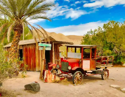 Tropical shack with tree in front, old fashioned red and white wagon
