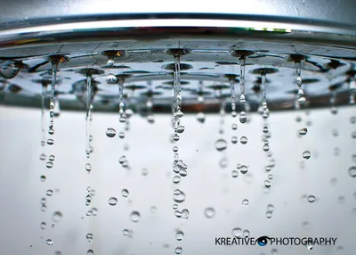 Water droplets falling from faucet
