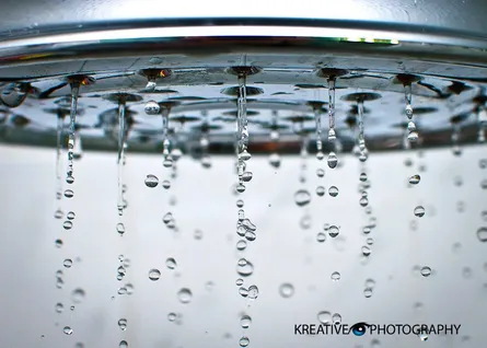 Water droplets falling from faucet