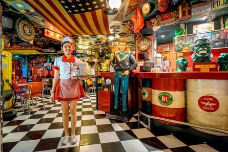 Diner waitress with phone, american flag backdrop