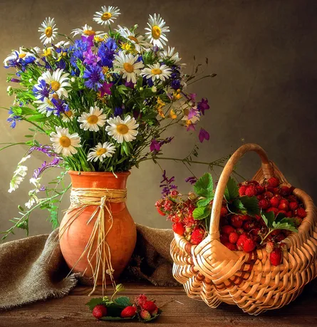 Bouquet of flowers near basket of strawberries