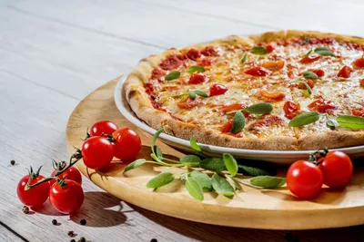 Uncooked pizza on wooden table