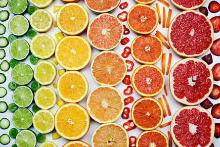 Colorful citrus fruits arranged in rows