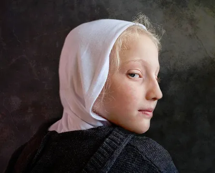A young girl with white headscarf