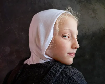 A young girl with white headscarf