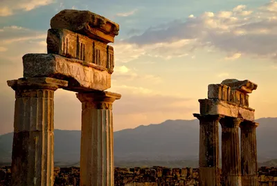 Stone pillars sunset clouds mountain landscape