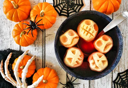 Bowl of soup surrounded by Halloween decorations