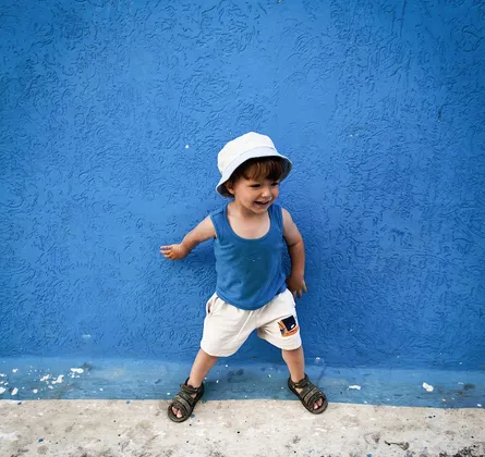 Child leaning against wall