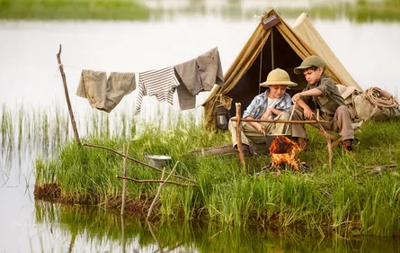 Two people sit in tent