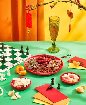 Festive chess set up, wine glass, candies, chess pieces