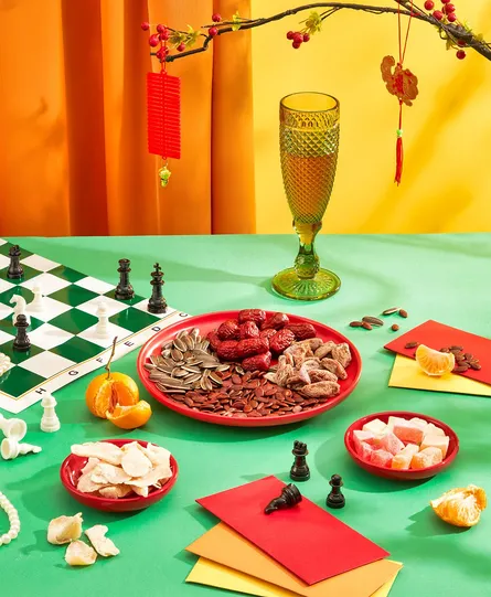 Festive chess set up, wine glass, candies, chess pieces