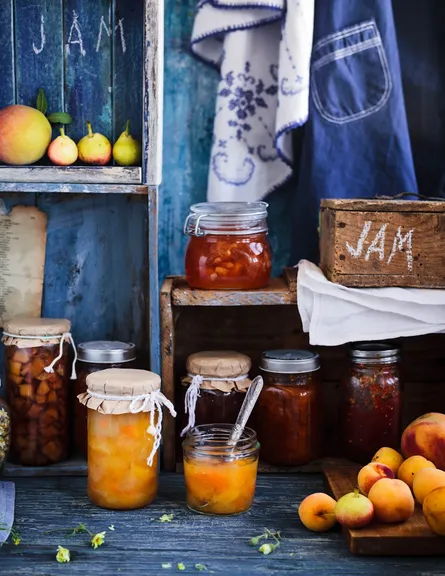Homemade jam, fruit display, blue wooden background
