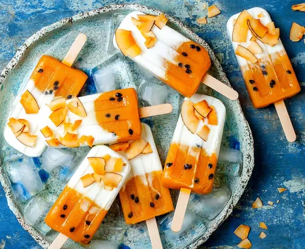 Orange and blue popsicles on plate
