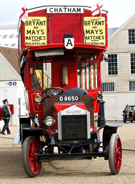 Red and white double decker bus on the street