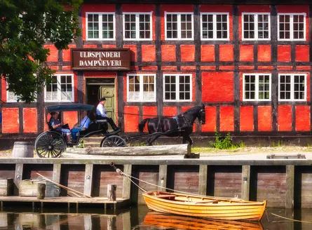 Red and white building by water