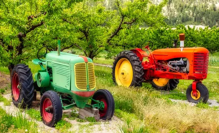 Two farm machines, one red tractor