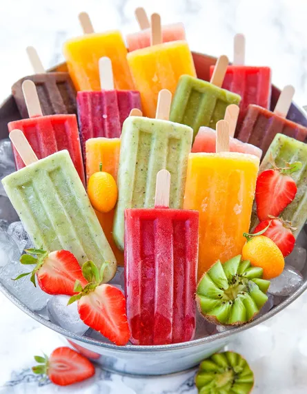 Colorful popsicles in bowl