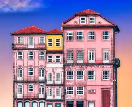 Pink and yellow building with white balconies