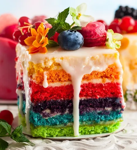 Colorful cake with whipped cream and fruit on top