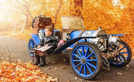 Child sitting on antique wagon