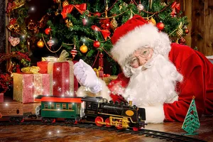 Festive santa claus next to train set