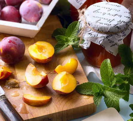 Stone fruits sliced on cutting board