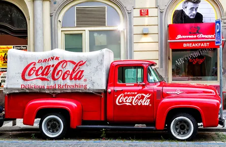 Red truck in front of sign