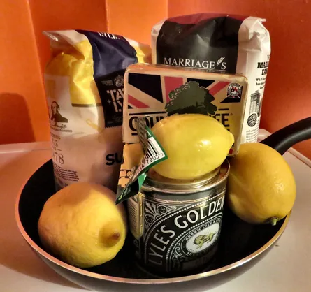 Lemon, flour and cookies on top of fruit bowl