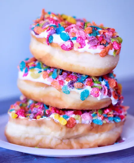 Colorful donuts on plate