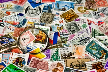 Postage stamps and magnifying glass