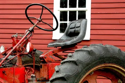 Old fashioned tractor with steering wheel on right