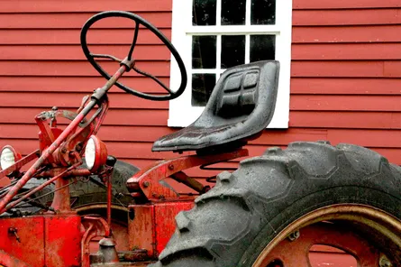 Old fashioned tractor with steering wheel on right