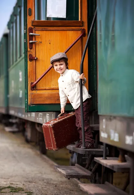 Boy with suitcase on train