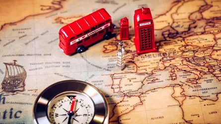 Red bus toy, compass, map