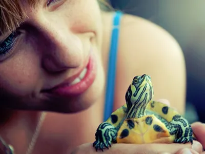 Young woman holding turtle