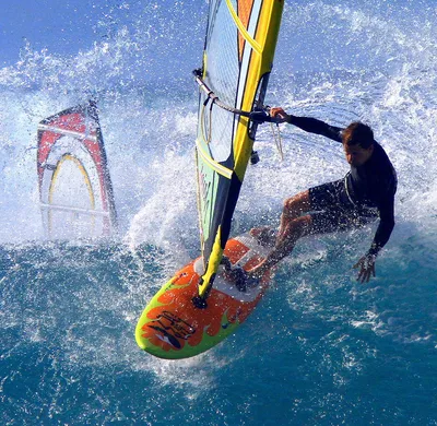 Surfer rides wave on surfboard